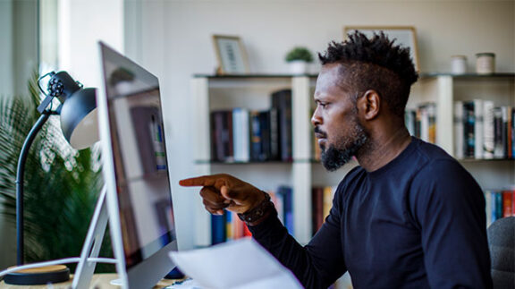 an employer looking at employee pay stubs