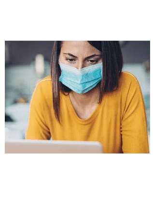 Woman wearing mask viewing laptop