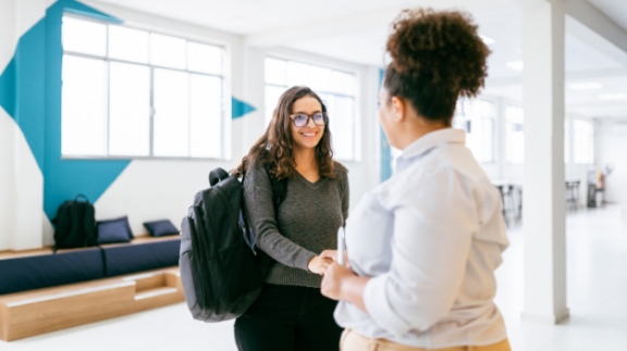 pair-of-women-shaking-hands-during-employee-onboarding