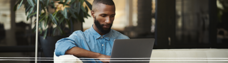 man-looking-at-computer-blue-shirt