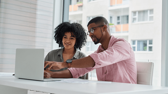 man and woman looking at laptop