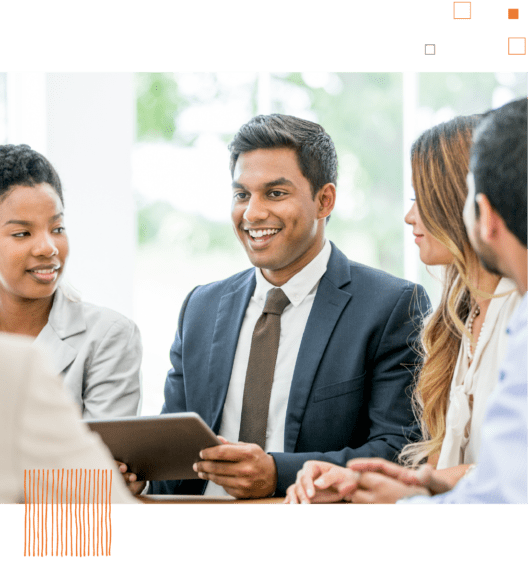 Man on tablet talking to group of coworkers