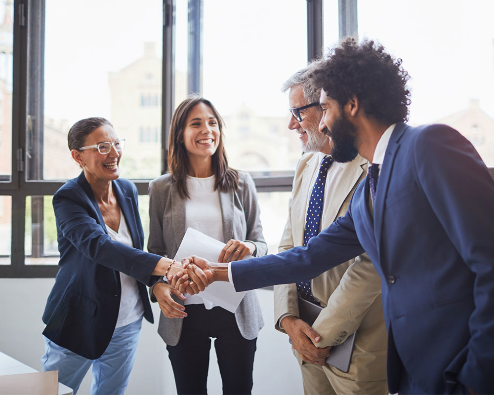 Group of people in suits shaking hands