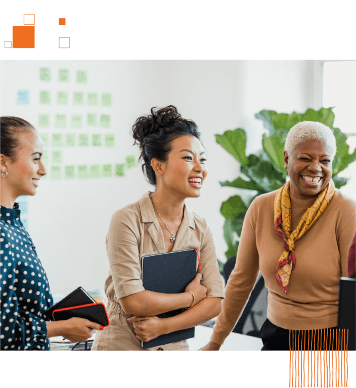 Group of three women talking in bright office