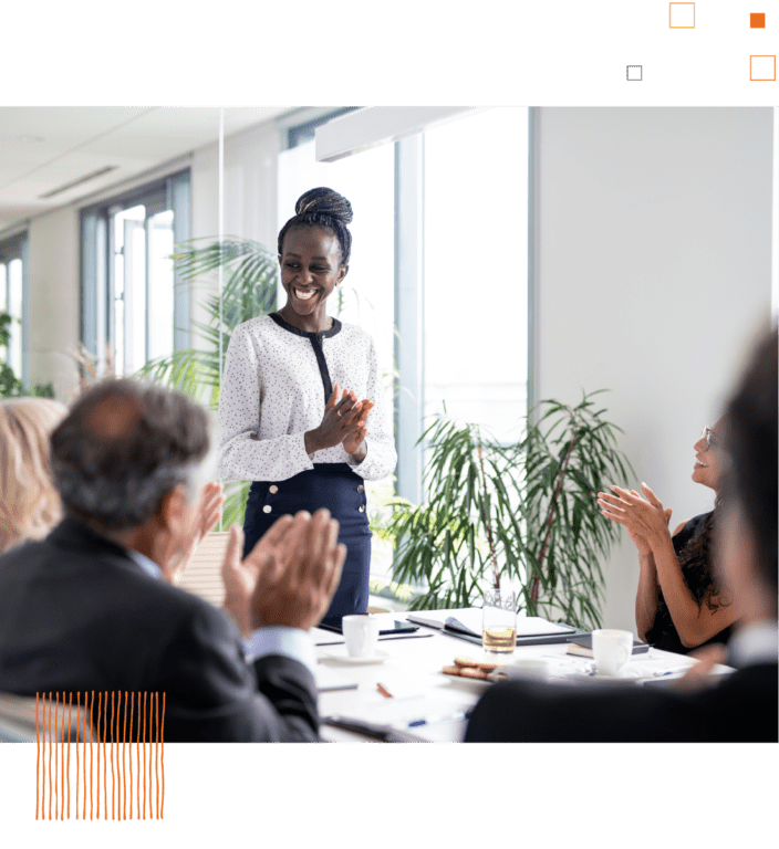 Woman presenting to coworkers at conference table