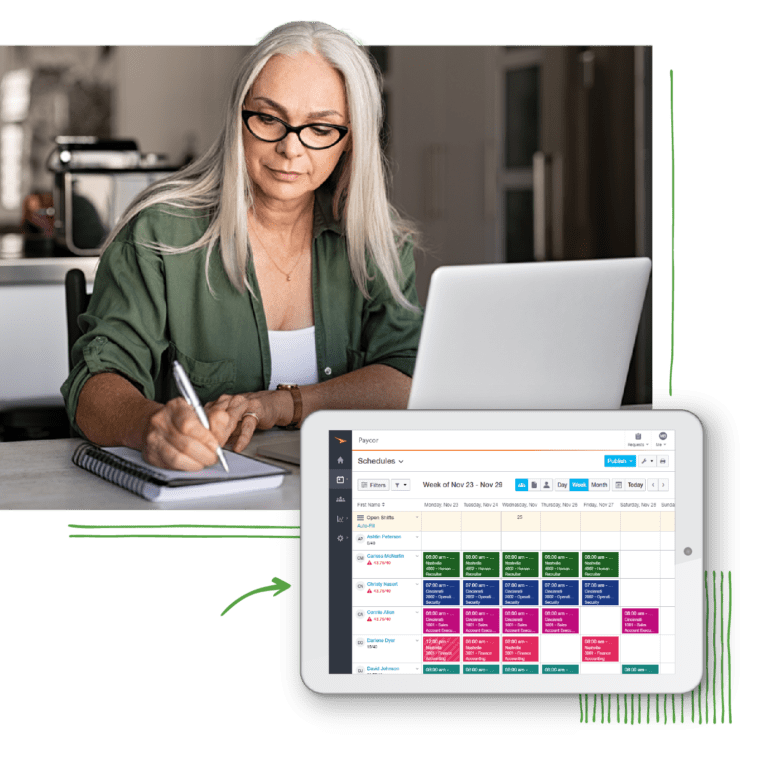 Woman writing notes in front of computer showing workforce calendar