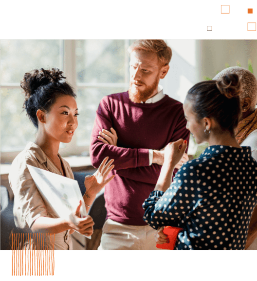 Woman talking to group of coworkers against bright office background