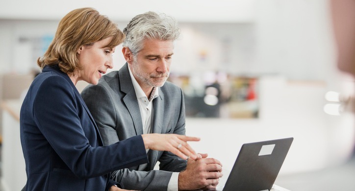 colleagues evaluating payroll system