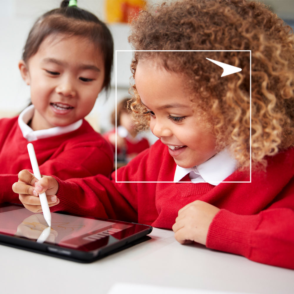 Two girls drawing on tablet