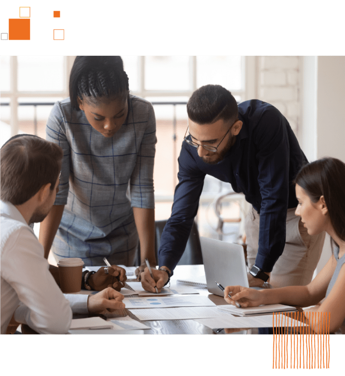 Group of coworkers working on papers over table