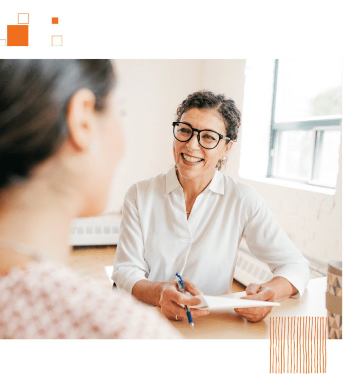 Woman sitting across desk interviewing