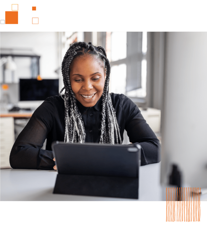 Woman sitting at desk with tablet