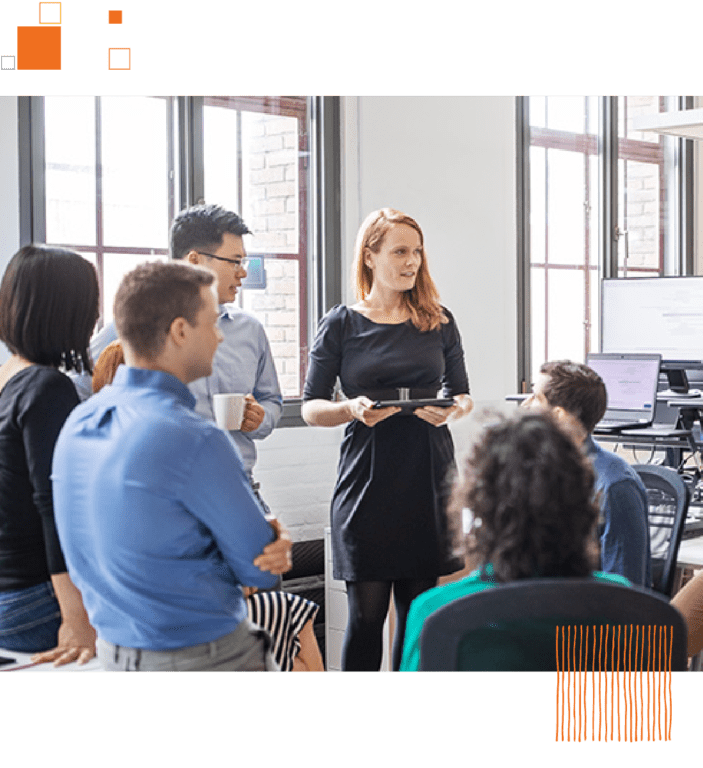 Group of co-workers talking in circle against office background