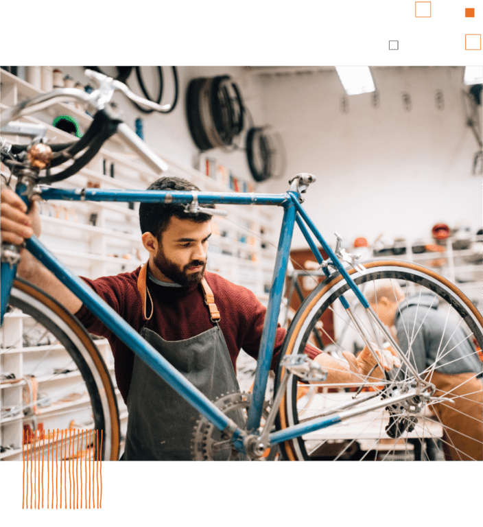 Man working on bike against workshop background