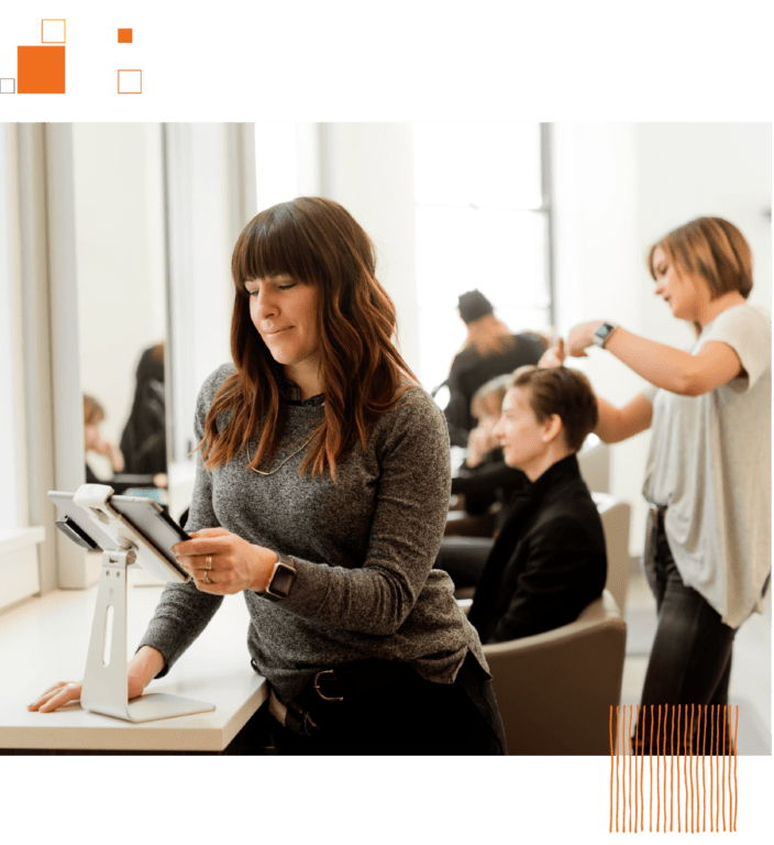 Woman looking at tablet in salon