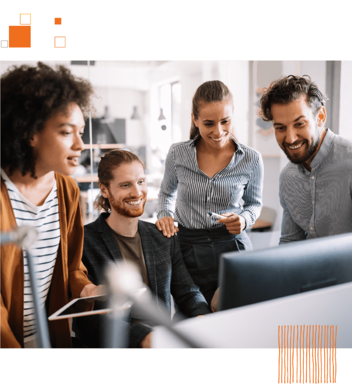 Group of coworkers gathered around computer