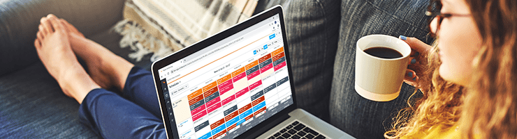 woman looking at work schedules on laptop