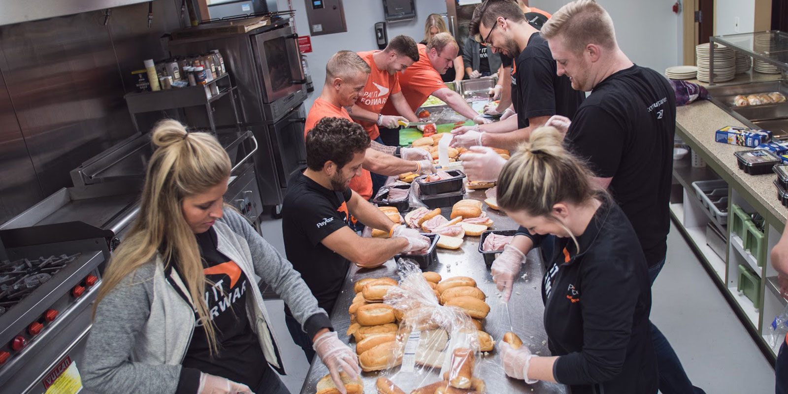 Paycor employees making meals for community service