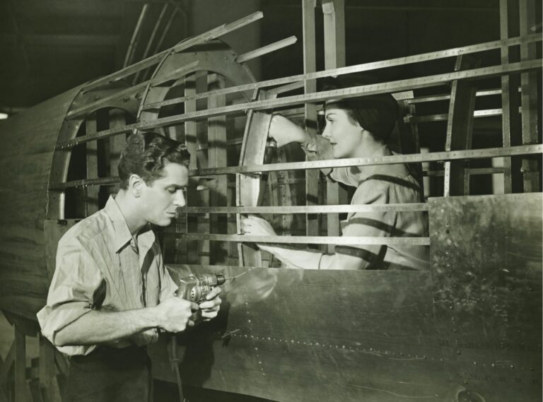 Man and woman assembling an airplane with black and white effect