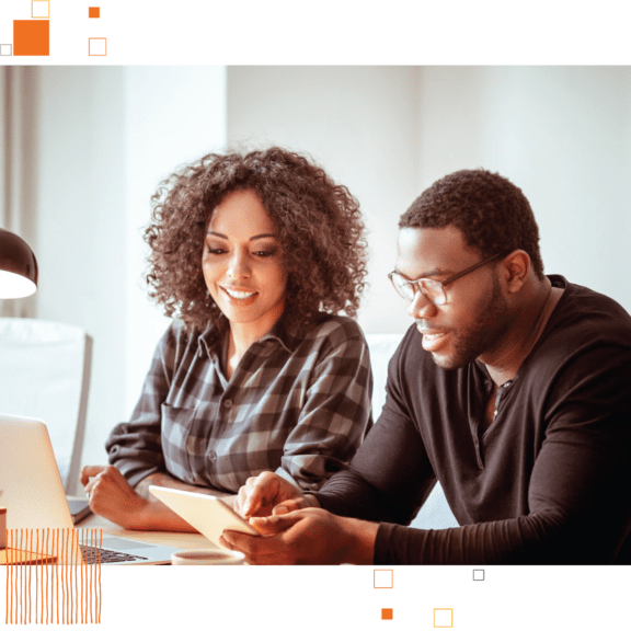 Male and female business partners reviewing notes