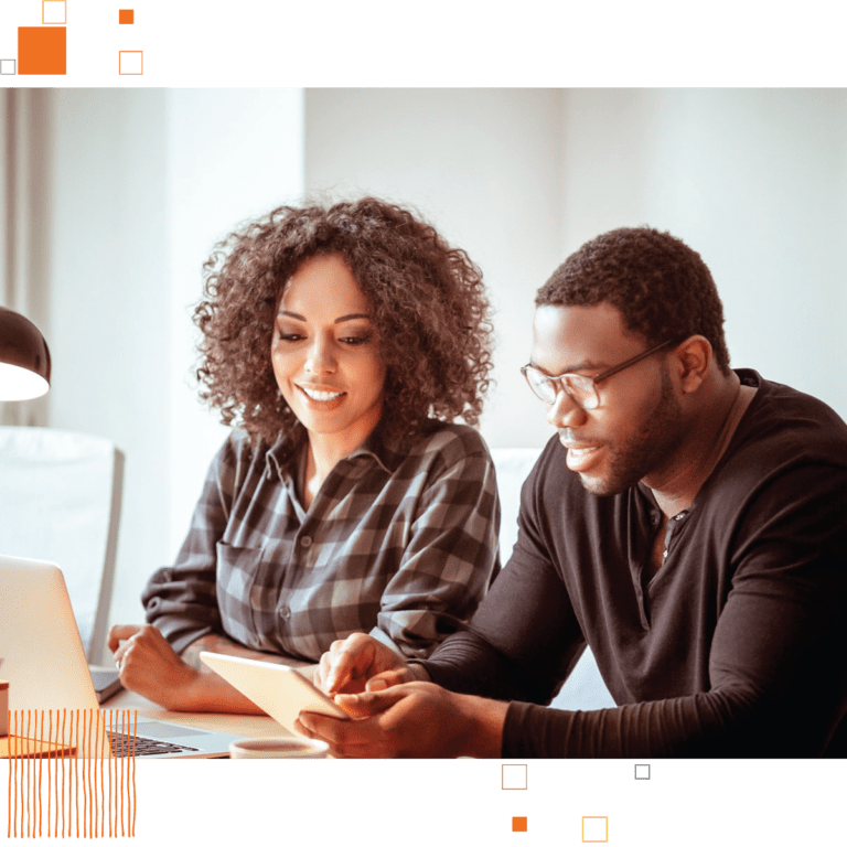 Male and female business partners reviewing notes