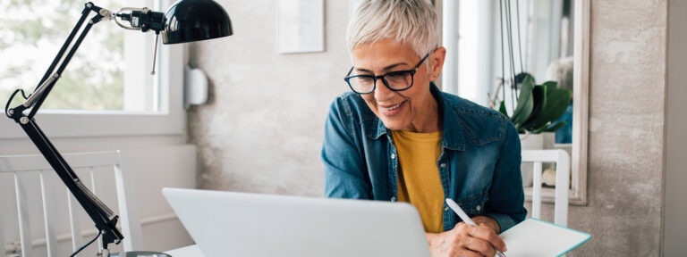 Female working from home office at a laptop computer