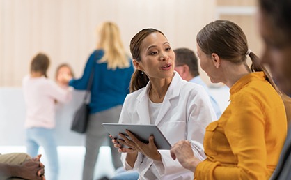 Female Doctor Talking To Female Patient