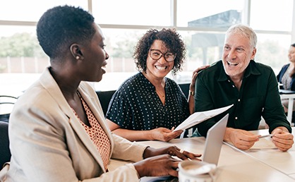 three professional at a conference table