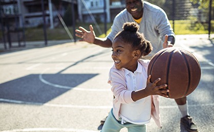 little girl playing basketball