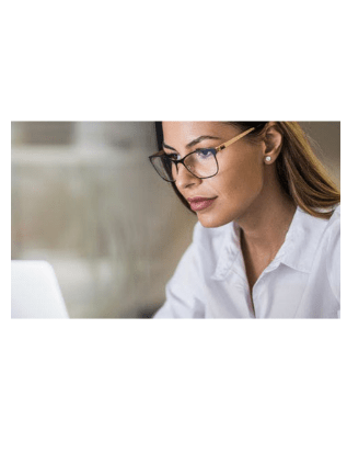 professional woman in glasses looking at computer screen