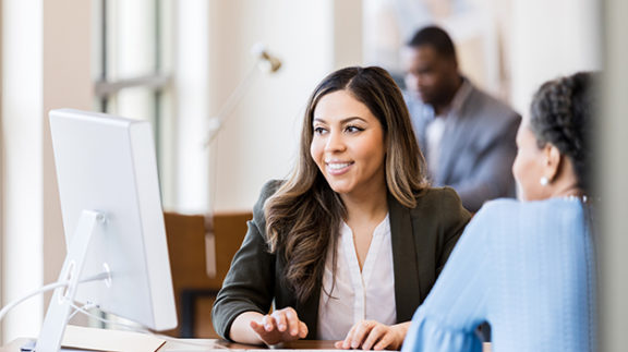 employee working with customer at computer