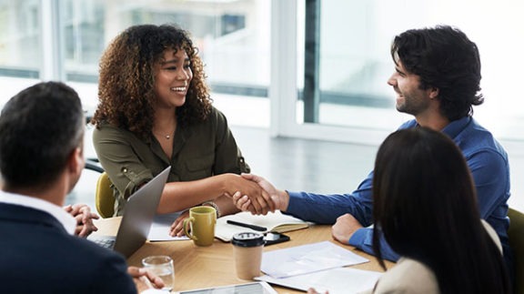 four professionals sitting at table