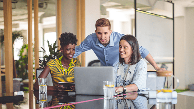 3 people working at a computer together