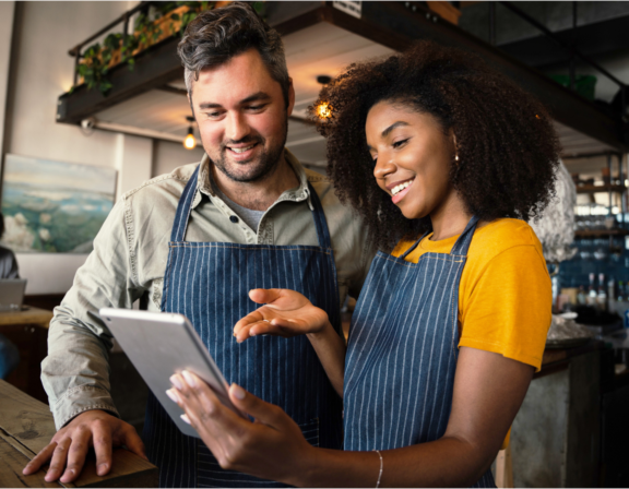 two restaurant owners looking at a ipad