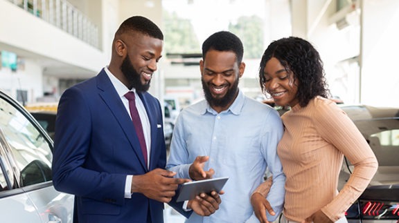 group smiling at cell phone