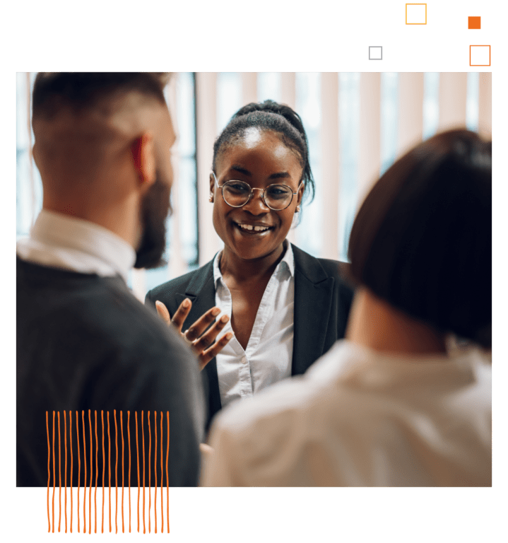 women in suit and glasses smiling and talking