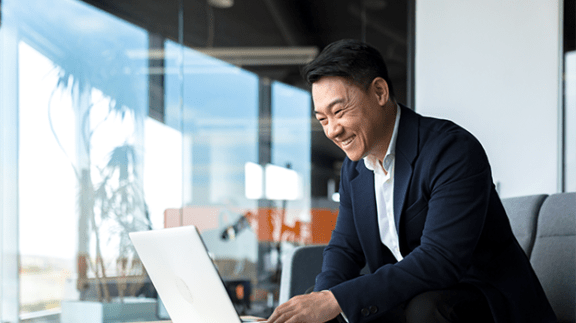 man smiling at computer