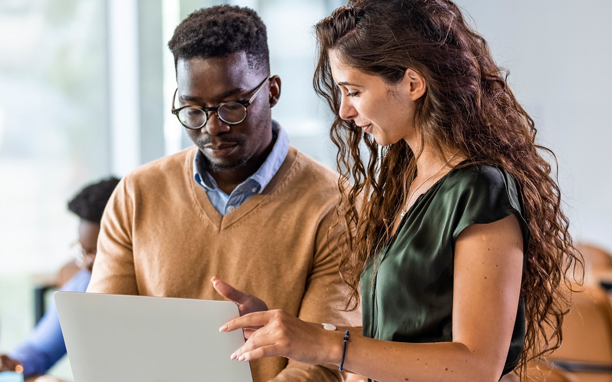 man and woman looking at a laptop