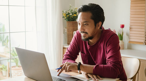 Guy working on taxes on computer