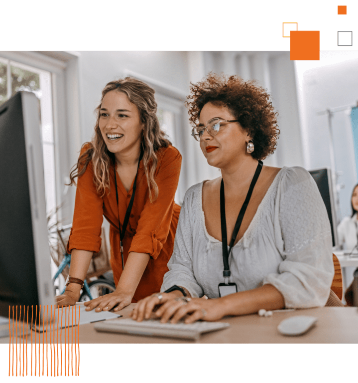 two women at a computer looking at a screen