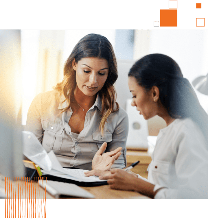 two women conferencing over documents