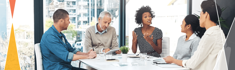 five professionals meeting around a white table