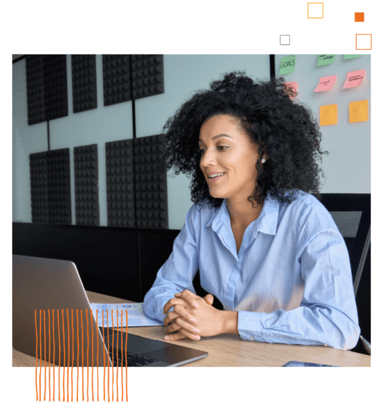 professional woman sitting at a table with a laptop