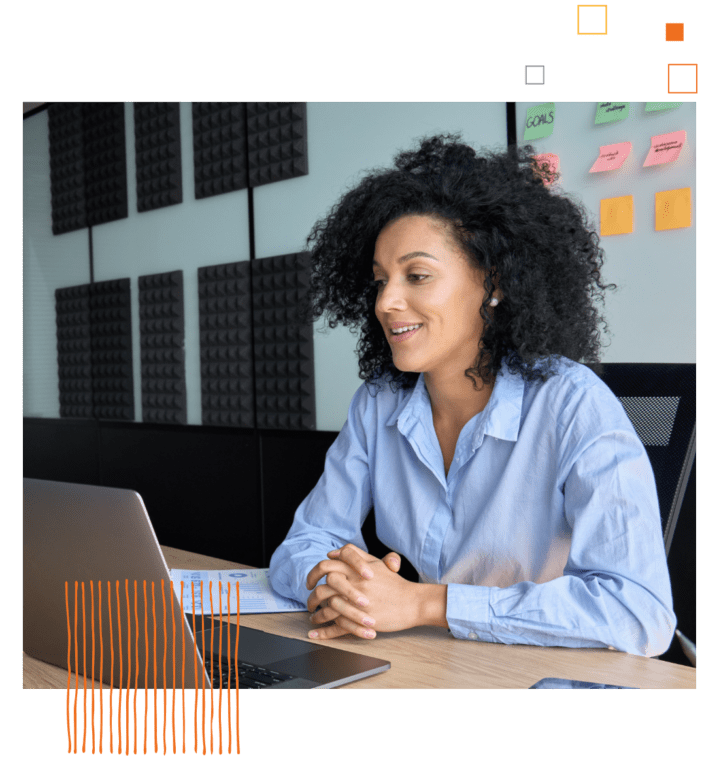 professional woman sitting at a table with a laptop