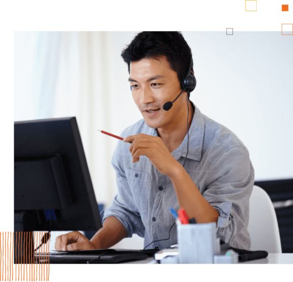 man holding pencil with headset working on computer