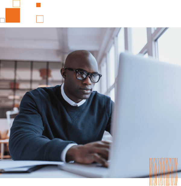 man in office using laptop