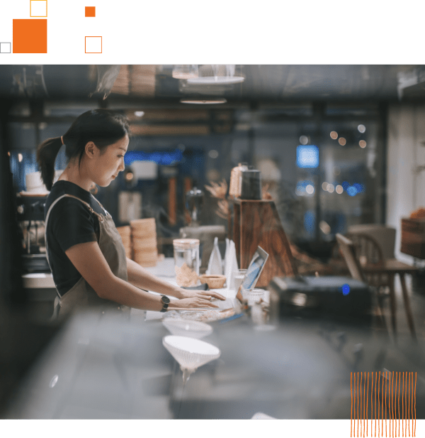 restaurant employee using laptop at counter
