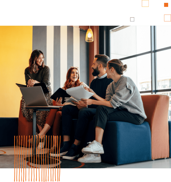 group of workers sitting around computer talking