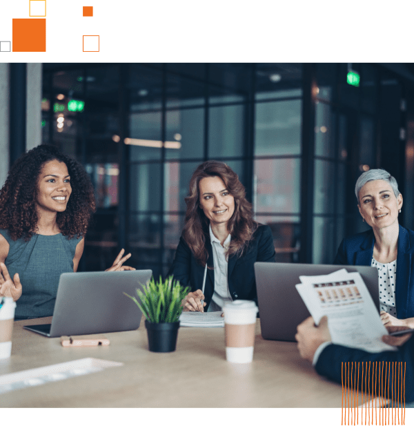 three female business professionals sitting at table