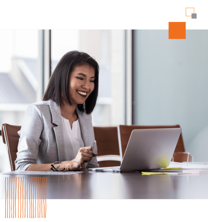 smiling woman looking at laptop